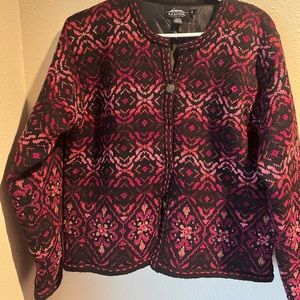 Icelandic buttoned burgundy brown pink with black background.